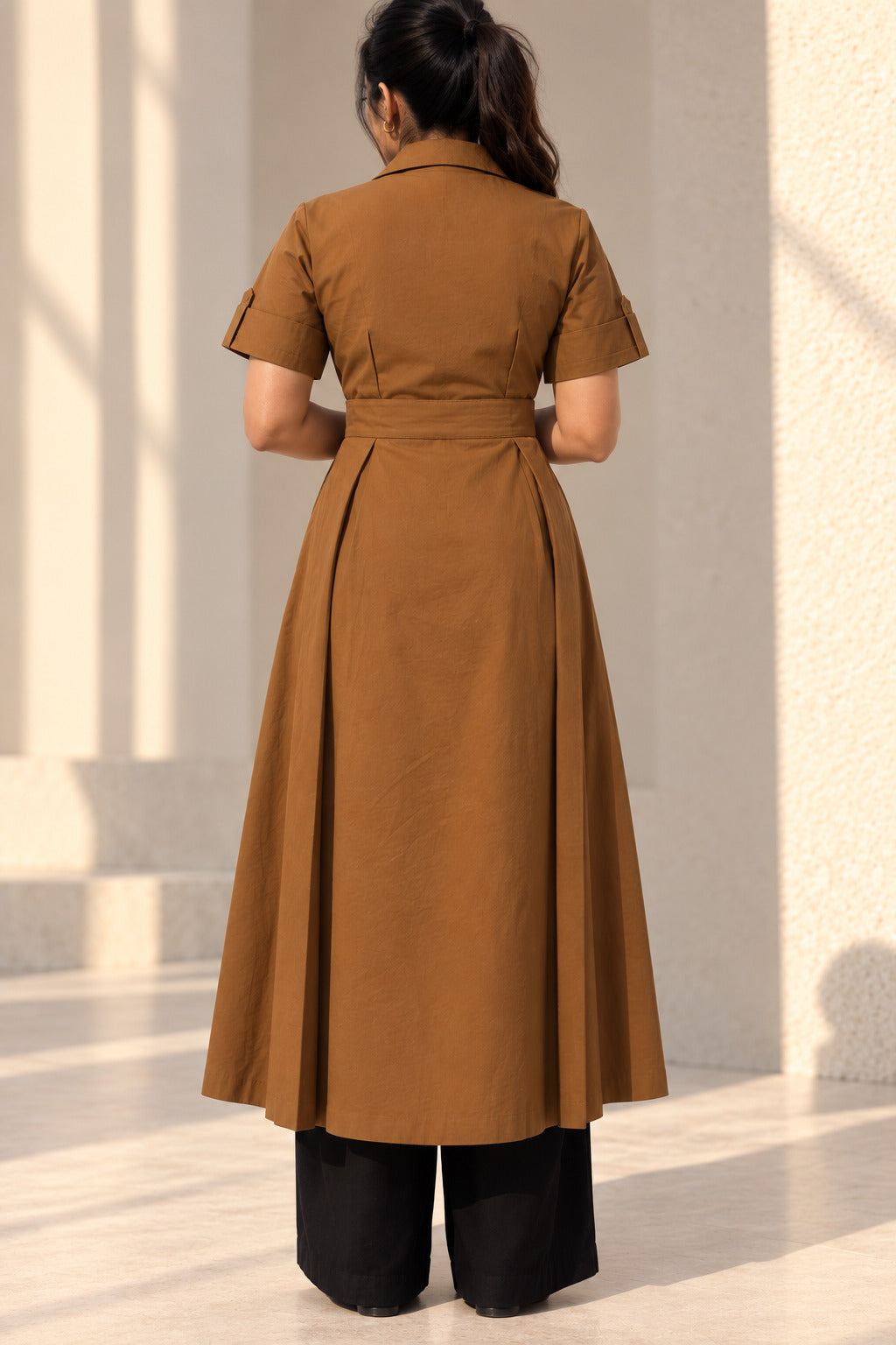 Back view of chestnut brown kurta showing fitted waist, box pleats and flared longline fall