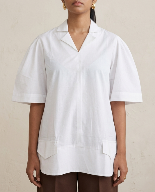 Close-up of white short kurta showing open collar, V-neck opening, wide-hem elbow sleeves and front flap pocket detail