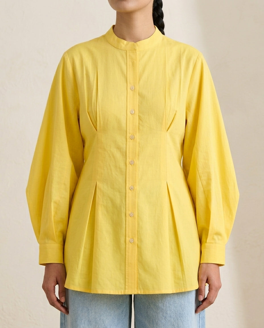 Close-up of Yellow Bishop Sleeve Kurti by Swayra, mandarin collar, front pleats and pearl buttons.