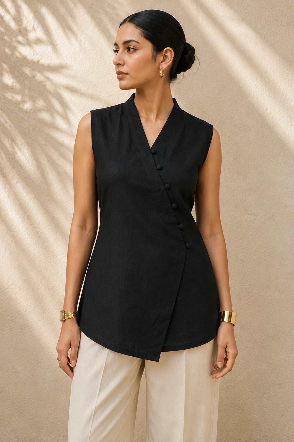 Black wrap kurta front view showing V-neck wrap, diagonal loop button placket and asymmetric hem