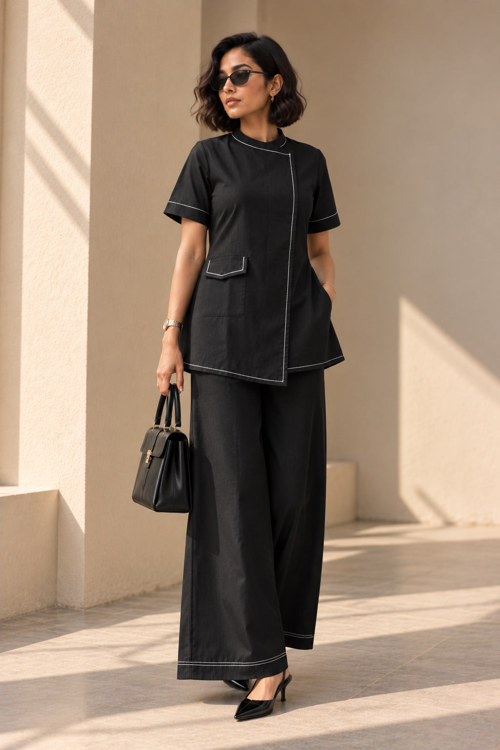 Black contrast stitch overlap kurta set, full front view, band collar and overlap front with wide-leg palazzos