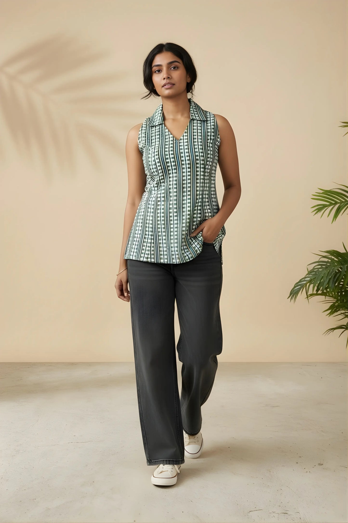 Full length model standing view of blue corset-style tunic styled with denim