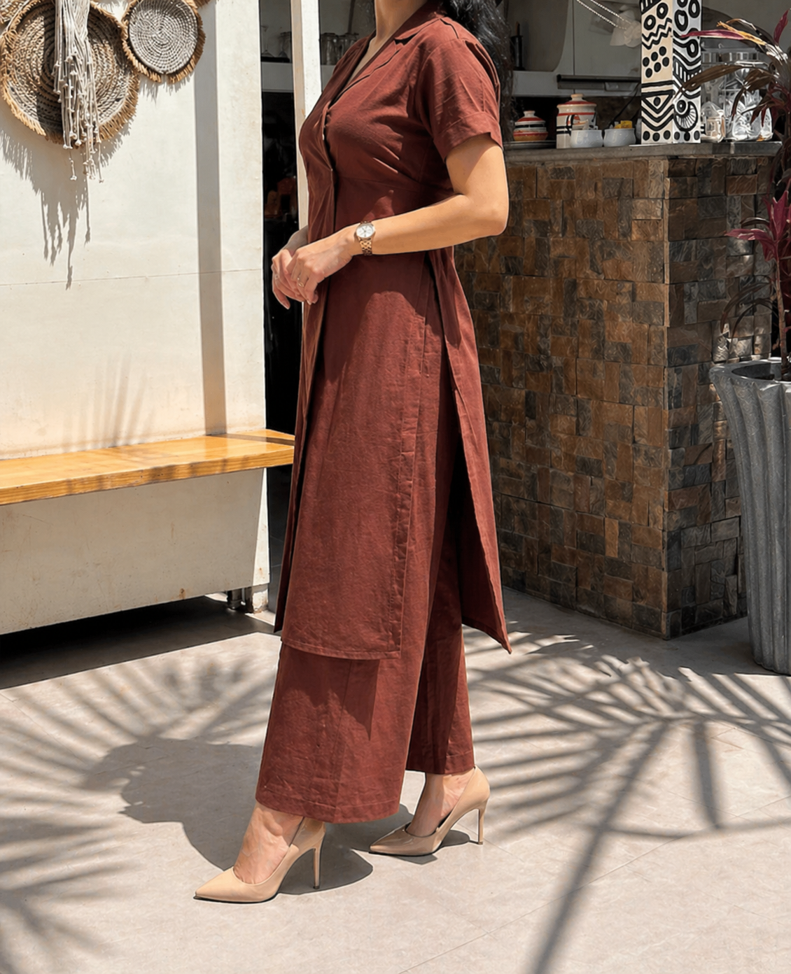 Three-quarter view highlighting the high side slits and the depth of the Coffee Brown fabric.