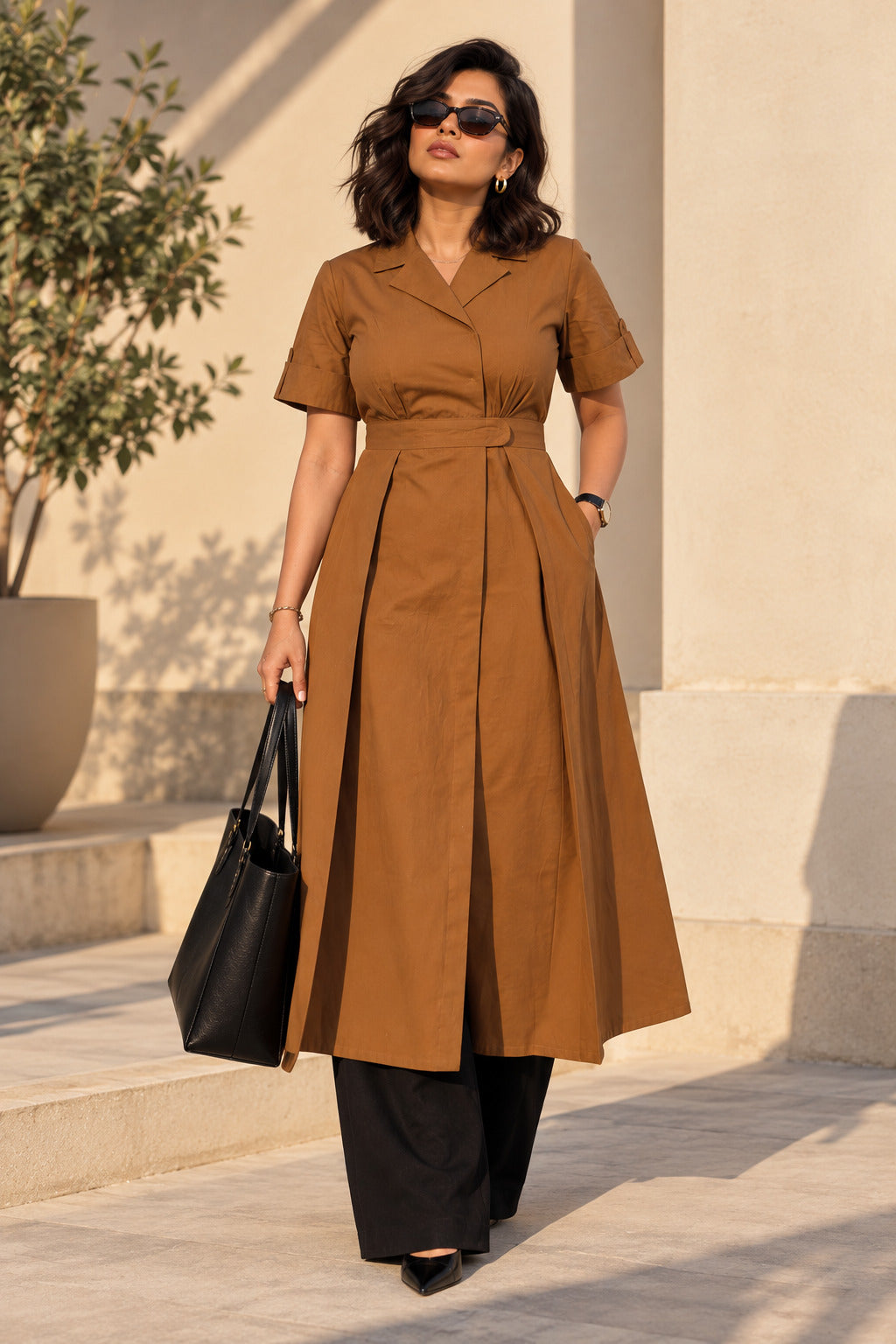 Chestnut brown pleated wrap kurta, full front view, blazer-style collar and waistband, styled with black wide-leg trousers