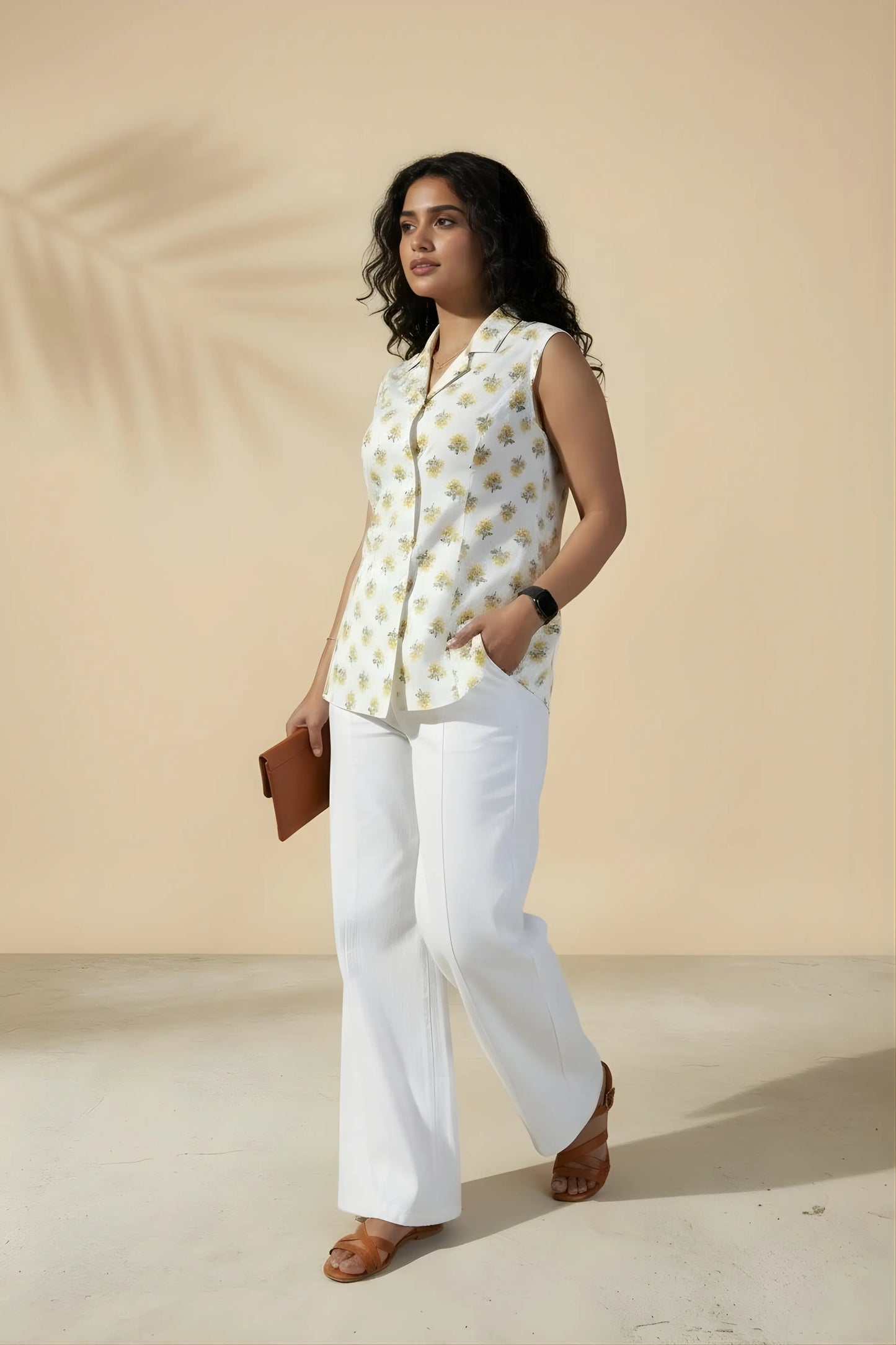 3/4th standing view of white sleeveless office top showing side fit