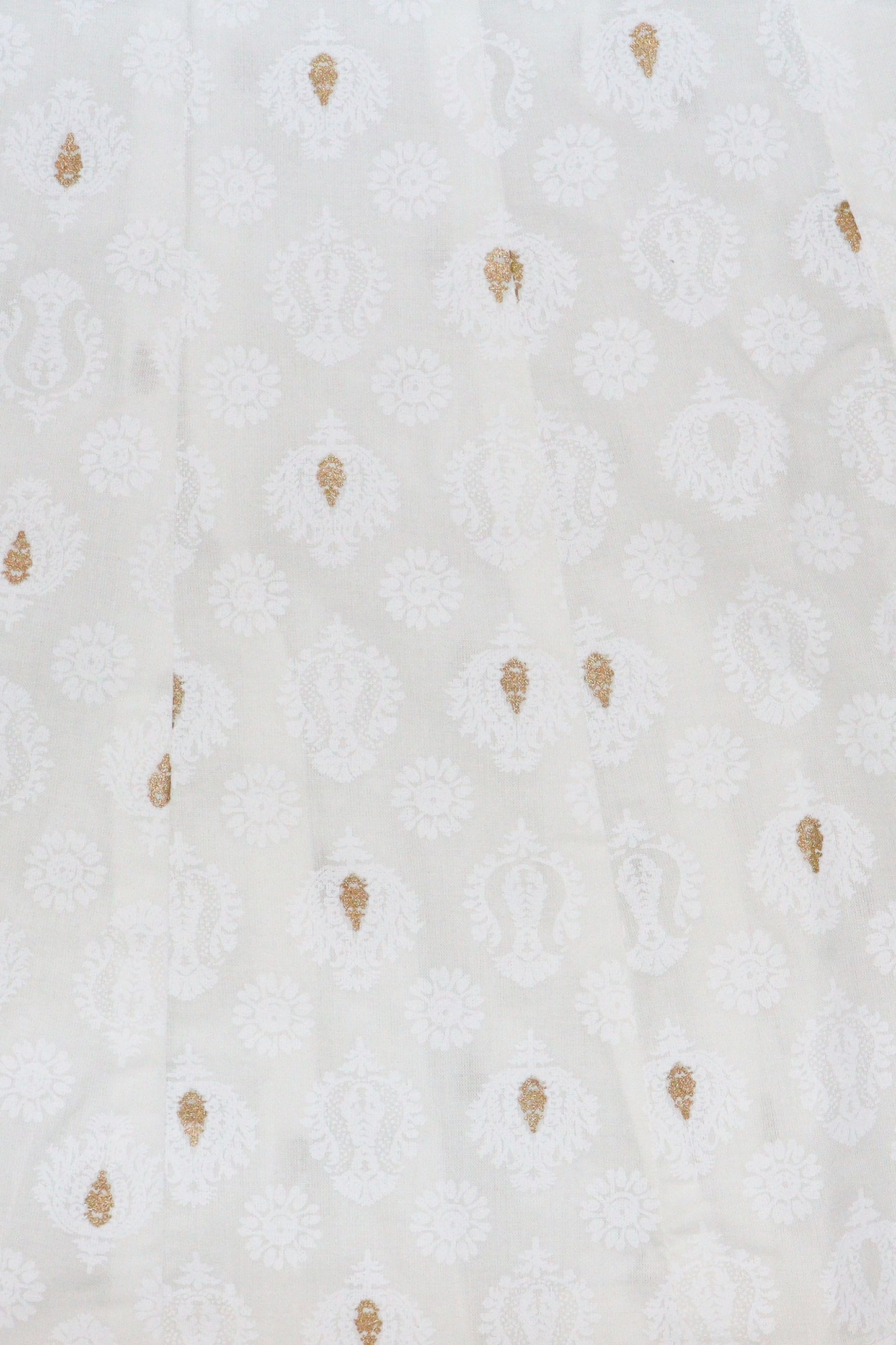 Close up detail of gold motifs on white khadi cotton fabric