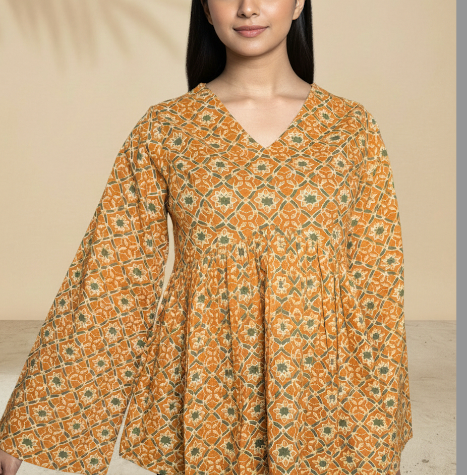 Upper body view of mustard peplum top showing empire waist fit