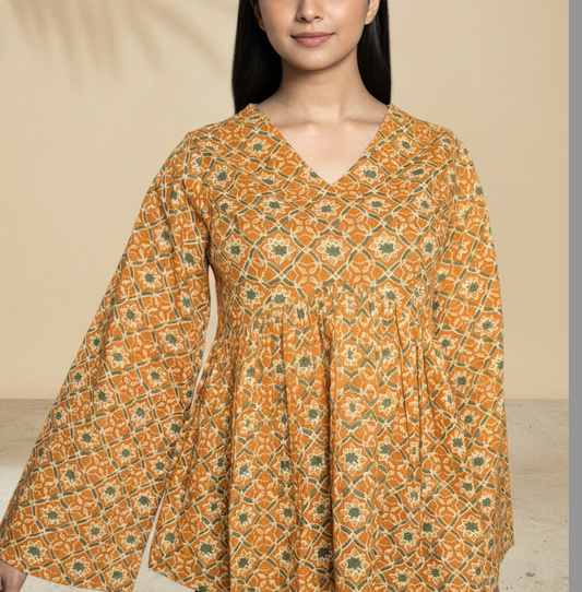 Upper body view of mustard peplum top showing empire waist fit