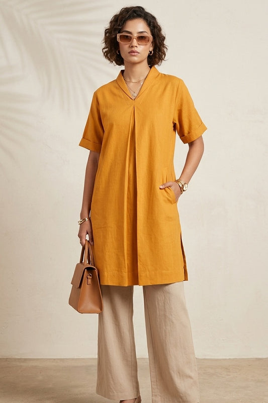 Mustard Front Pleated Box Fit Kurta by Swayra, worn with wide-leg beige trousers, block heels and tan tote