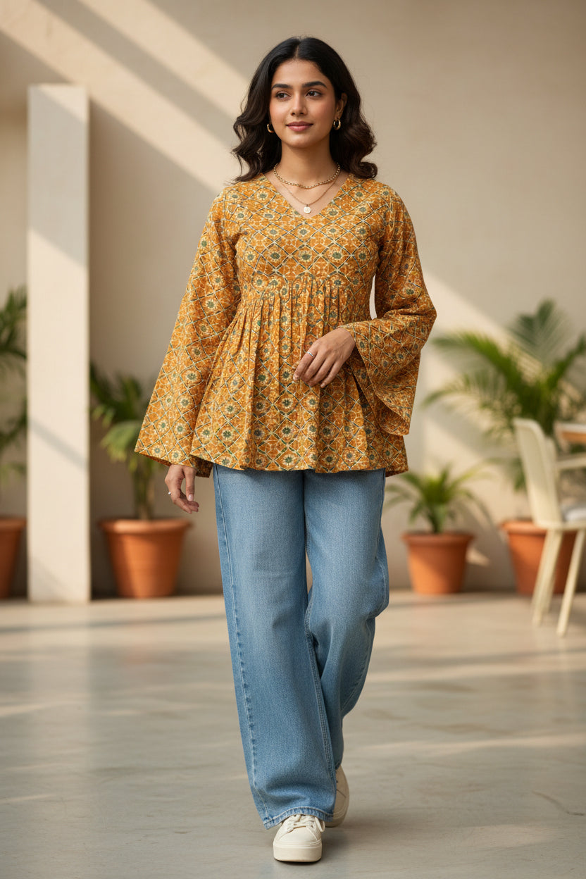 Mustard yellow geometric print peplum short kurti styled with jeans front view