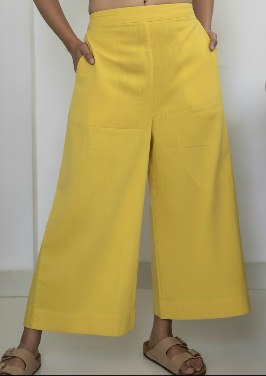 Detail view of solid yellow wide-leg palazzos included in the set