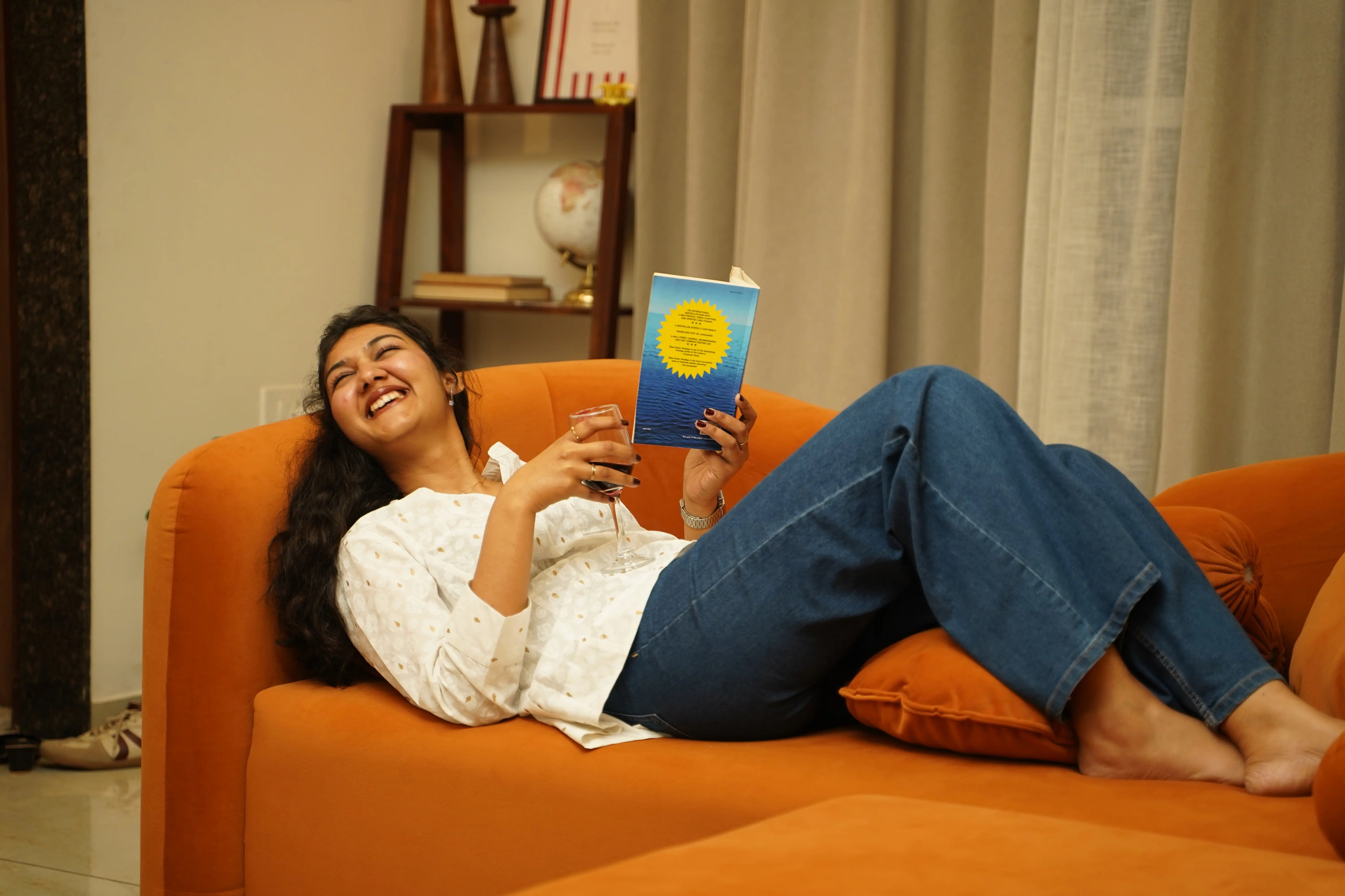 Woman laughing in a white short Swayra kurta styled with denim, showcasing modern Indian workwear that moves easily from work to life.