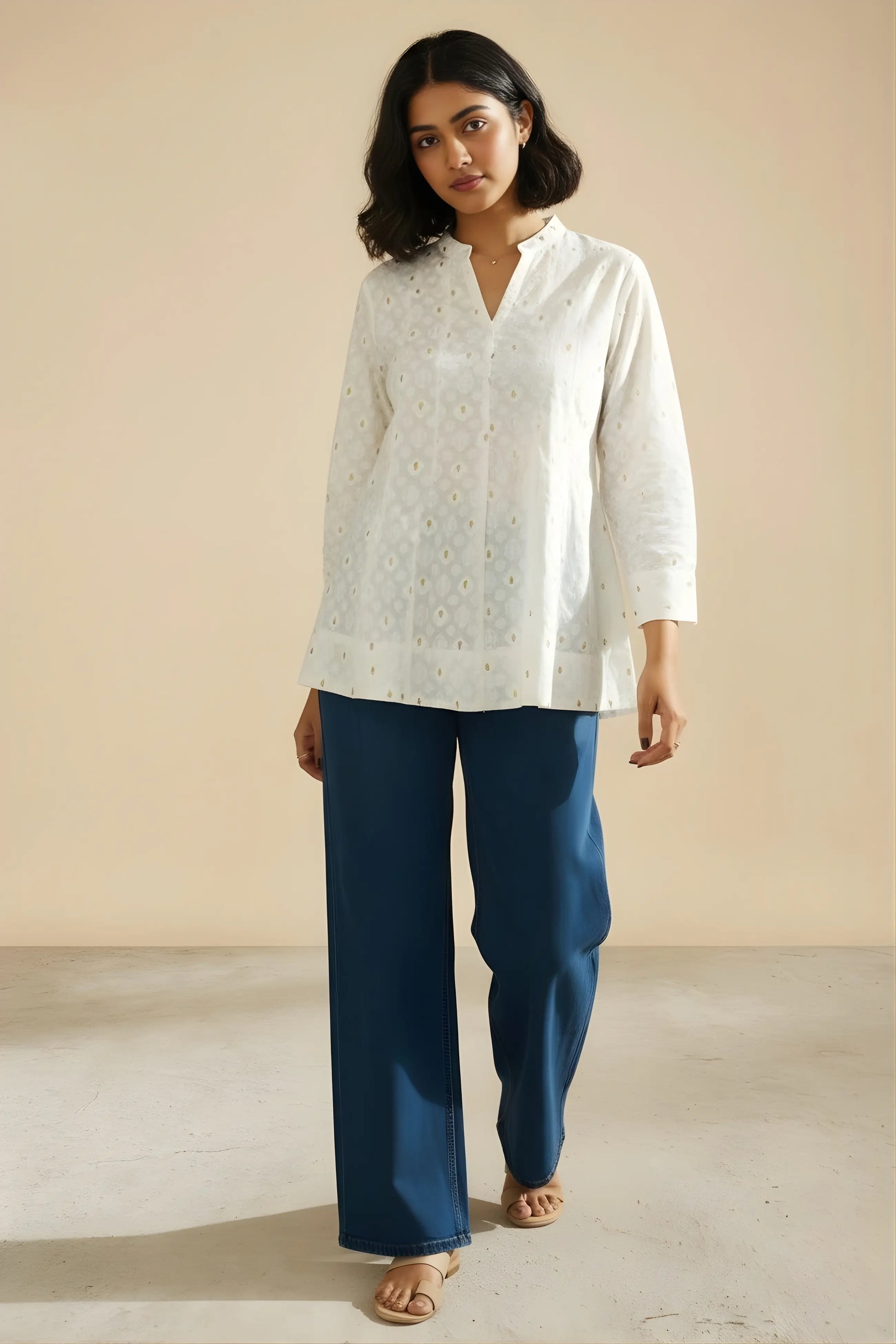 Woman wearing white office kurta standing pose showing fit