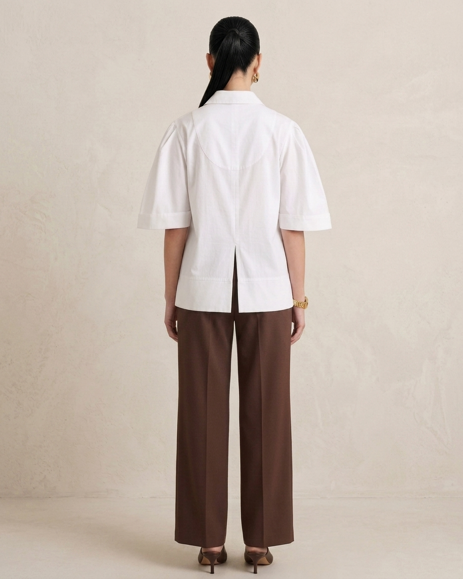 Back view of white flap pocket short kurta showing centre back pleat and wide-hem elbow sleeves