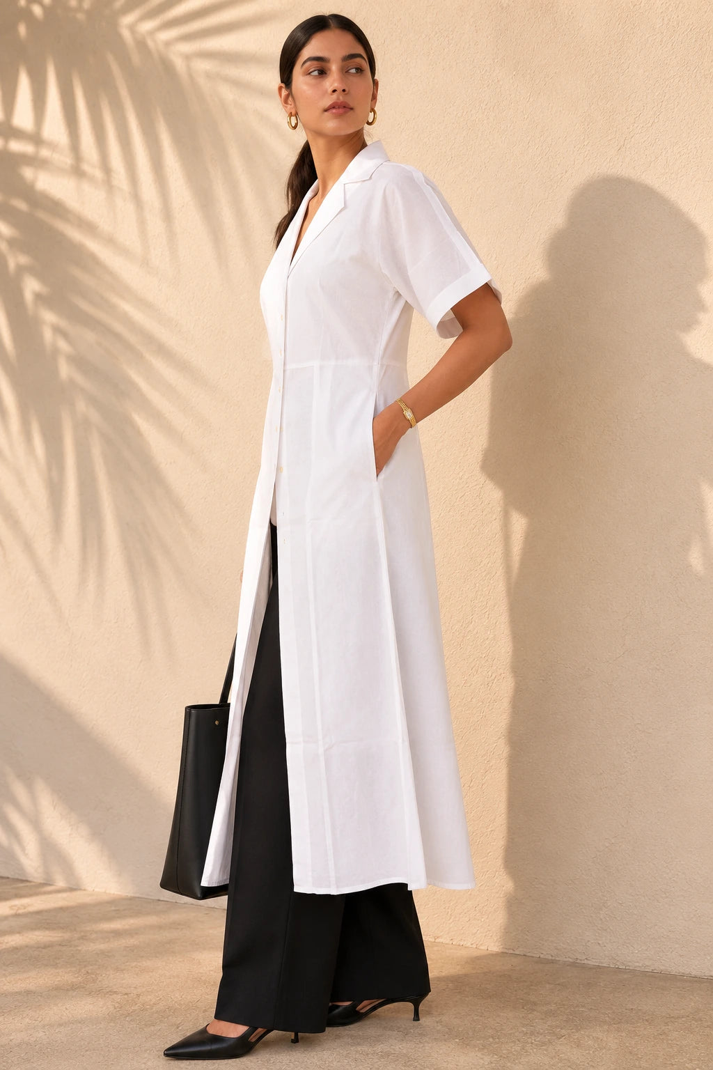 Side view of white A-line shirt kurta showing fitted bodice, A-line flare, side pocket and short folded cuff sleeves